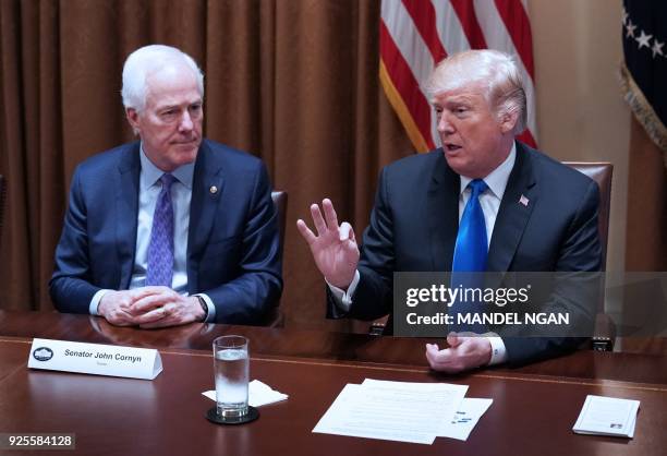 President Donald Trump speaks watched by Senator John Cornyn, R-TX, during a meeting with bipartisan members of Congress on school and community...