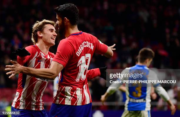Atletico Madrid's French forward Antoine Griezmann celebrates his fourth goal with Atletico Madrid's Spanish forward Diego Costa during the Spanish...