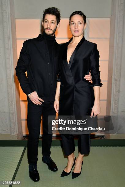 Pierre Niney and Natasha Andrews attend the H&M show as part of the Paris Fashion Week Womenswear Fall/Winter 2018/2019 on February 28, 2018 in...