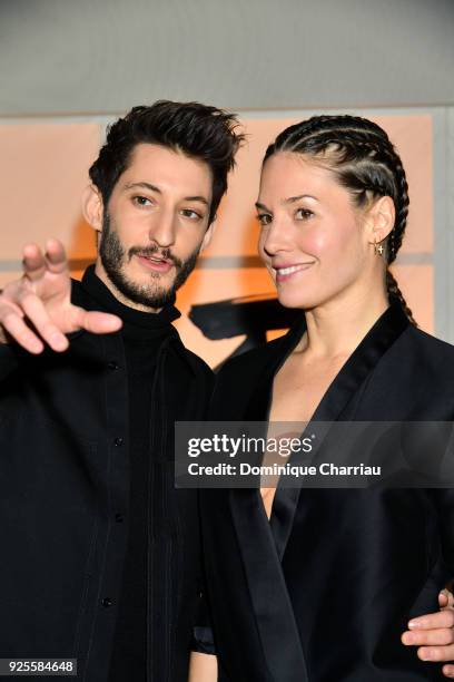 Pierre Niney and Natasha Andrews attend the H&M show as part of the Paris Fashion Week Womenswear Fall/Winter 2018/2019 on February 28, 2018 in...