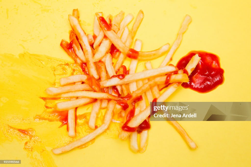 Greasy French Fries With Ketchup On Yellow Background