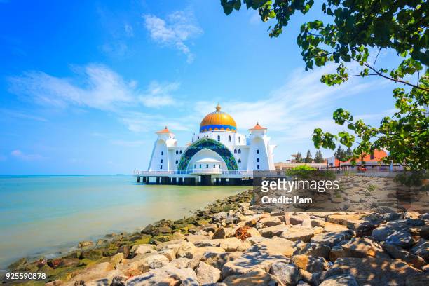 malacca straits mosque during sunrise - masjid selat melaka. it is a mosque located on the man-made malacca island near malacca town. malaysia - masjid selat melaka stock pictures, royalty-free photos & images