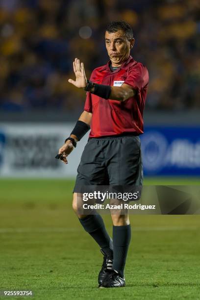 Referee Joel Aguilar gestures during the second leg match between Tigres UANL and Herediano as part of round of 16 of the CONCACAF Champions League...
