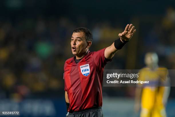 Referee Joel Aguilar gestures during the second leg match between Tigres UANL and Herediano as part of round of 16 of the CONCACAF Champions League...