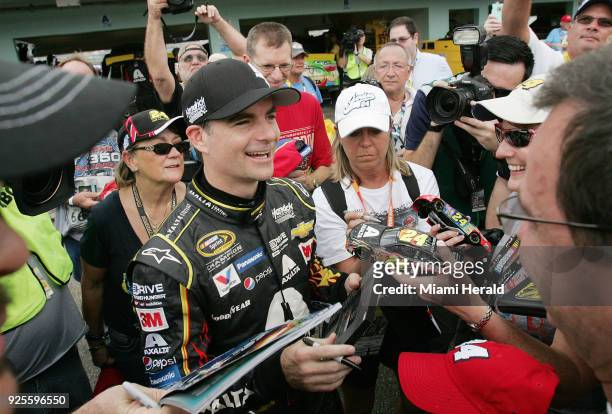 Driver Jeff Gordon signs autographs for fans during the Ford EcoBoost 400 Sprint Cup Series practice on Saturday, Nov. 21 at Homestead-Miami Speedway...