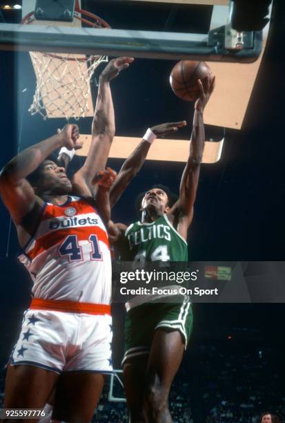 Dave Bing of the Boston Celtics shoots over Wes Unseld of the Washington Bullets during an NBA basketball game circa 1977 at the Capital Centre in...