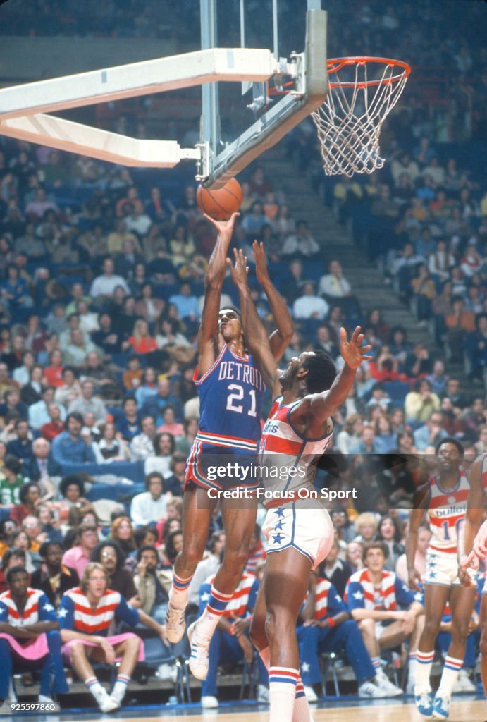 Dave Bing of the Detroit Pistons shoots over Elvin Hayes of the... News ...
