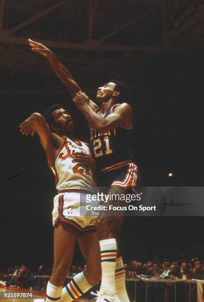 Dave Bing of the Detroit Pistons shoots over Archie Clark of the Philadelphia 76ers during an NBA basketball game circa 1968 at The Spectrum in...