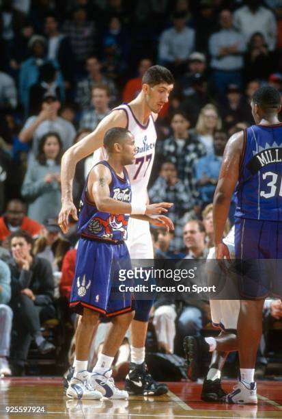 Gheorghe Muresan of the Washington Bullets looks on Toronto Raptors during an NBA basketball game circa 1995 at the US Airways Arena in Landover,...