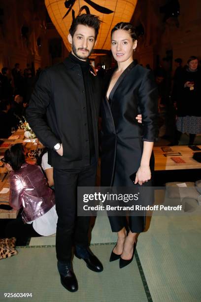 Pierre Niney and Natasha Andrews attend the H&M show as part of the Paris Fashion Week Womenswear Fall/Winter 2018/2019 on February 28, 2018 in...