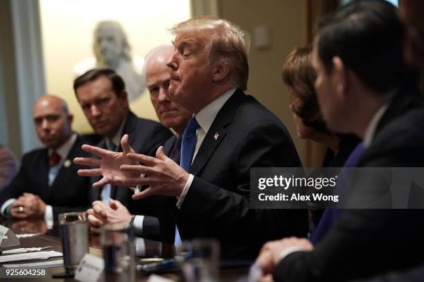 President Donald Trump speaks as Sen. Christopher Murphy , Senate Majority Whip Sen. John Cornyn and Sen. Marco Rubio listen during a meeting with...