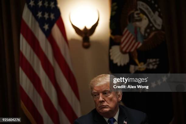 President Donald Trump listens during a meeting with bipartisan members of the Congress at the Cabinet Room of the White House February 28, 2018 in...