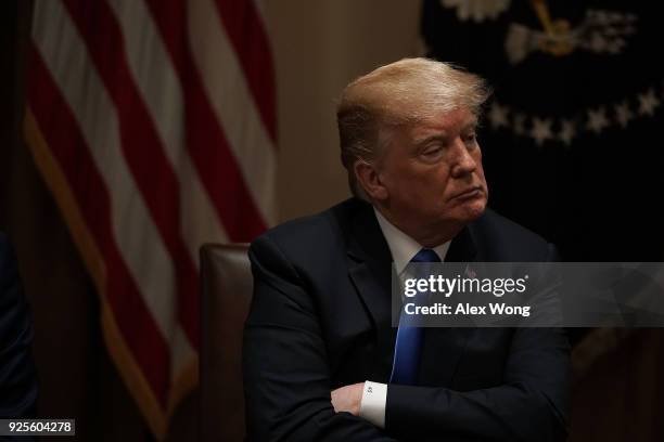 President Donald Trump listens during a meeting with bipartisan members of the Congress at the Cabinet Room of the White House February 28, 2018 in...