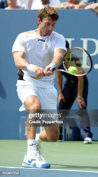 Juan Carlos Ferrero of Spain returns a shot againt Gael Monfils of France during Day Four of the 2011 US Open at the USTA Billie Jean King National...