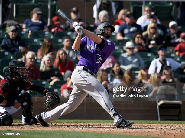 Colorado Rockies catcher Anthony Bemboom homers in the seventh inning to right center against the Arizona Diamondbacks on February 28, 2018 at Salt...