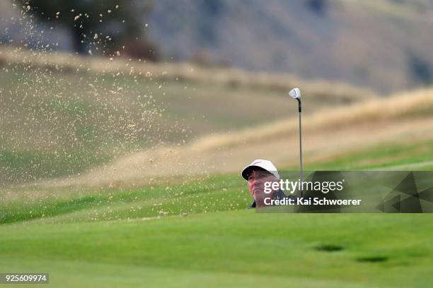 Former English cricketer Sir Ian Botham plays a bunker shot during day one of the ISPS Handa New Zealand Golf Open at The Hills Golf Club on March 1,...