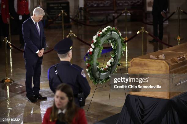 Supreme Court Associate Justice Neil Gorsuch bows his head in prayer while paying repects to Christian evangelist and Southern Baptist minister Billy...