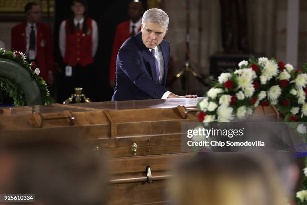 Supreme Court Associate Justice Neil Gorsuch touches the casket of Christian evangelist and Southern Baptist minister Billy Graham as he lies in...