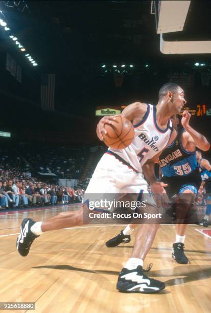 Juwan Howard of the Washington Bullets drives on Danny Ferry of the Cleveland Cavaliers during an NBA basketball game circa 1994 at the US Airways...