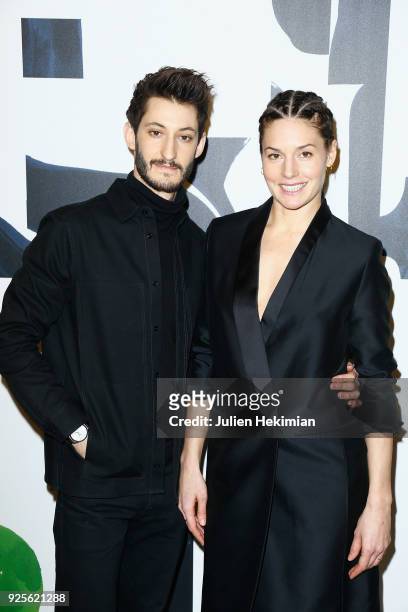 Pierre Niney and Natasha Andrews attend the H&M show as part of the Paris Fashion Week Womenswear Fall/Winter 2018/2019 on February 28, 2018 in...