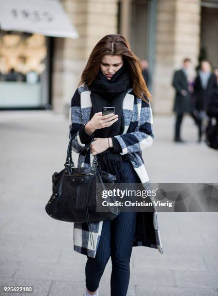 Luna Bijl wearing plaid wool coat is seen outside Lanvin on February 28, 2018 in Paris, France.