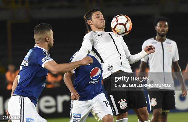 Brazil`s Corinthians player Angel Romero vies for the ball with Colombia's Millonarios players during their Copa Libertadores football match at the...