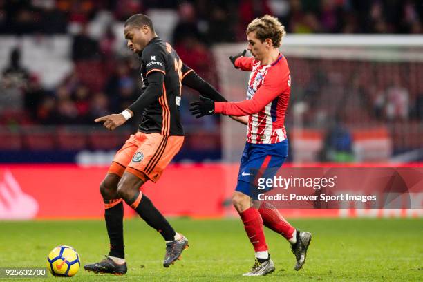 Geoffrey Kondogbia of Valencia CF fights for the ball with Antoine Griezmann of Atletico de Madrid during the La Liga 2017-18 match between Atletico...