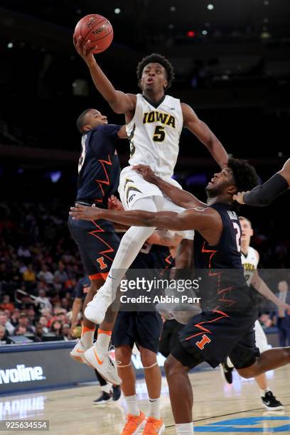 Tyler Cook of the Iowa Hawkeyes takes a shot against Kipper Nichols of the Illinois Fighting Illini in the second half during the Big Ten Basketball...
