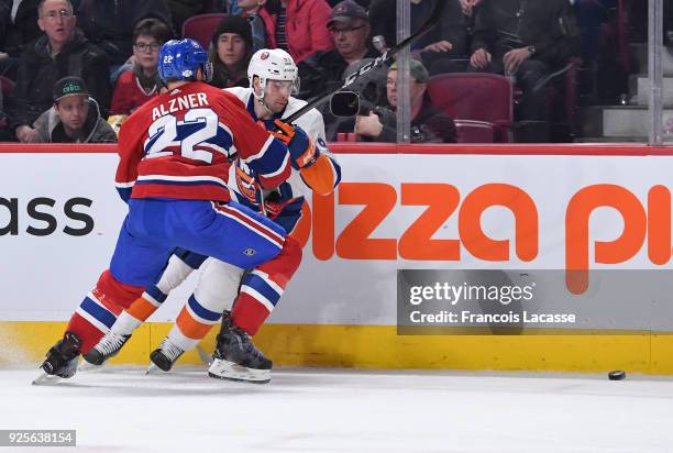 Karl Alzner of the Montreal Canadiens tries to slow down John Tavares of the New York Islanders in the NHL game at the Bell Centre on February 28,...