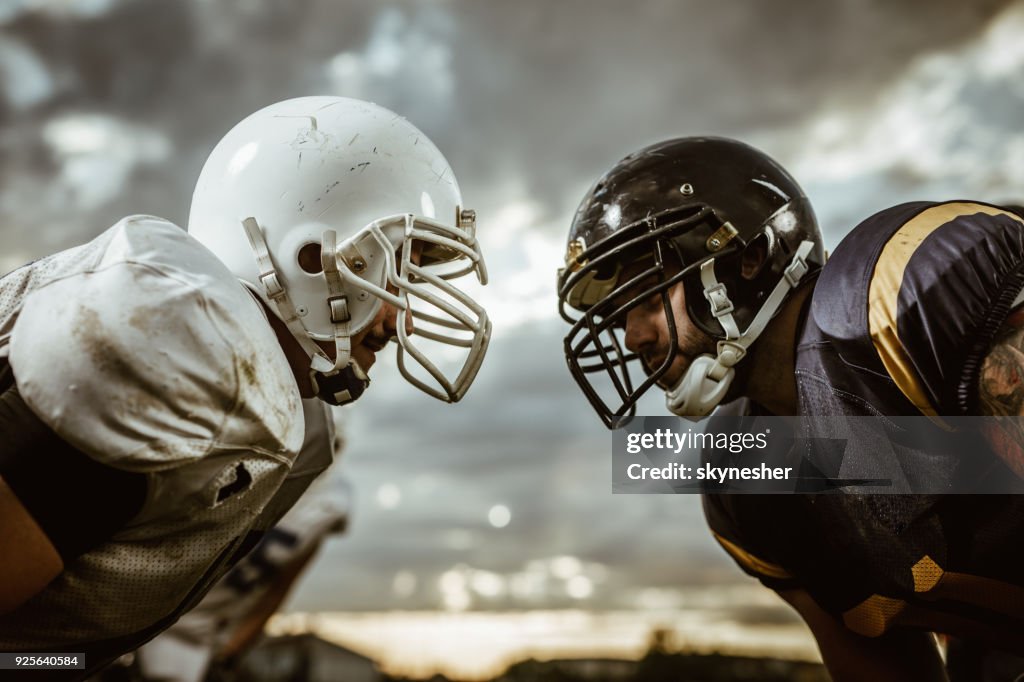 American football players confronting before the beginning of a match.