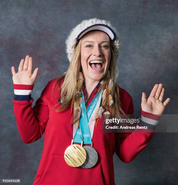 Snowboarder Jamie Anderson of the United States poses for a portrait with her gold medal for Ladies' Slopestyle and silver medal for Ladies' Big Air...