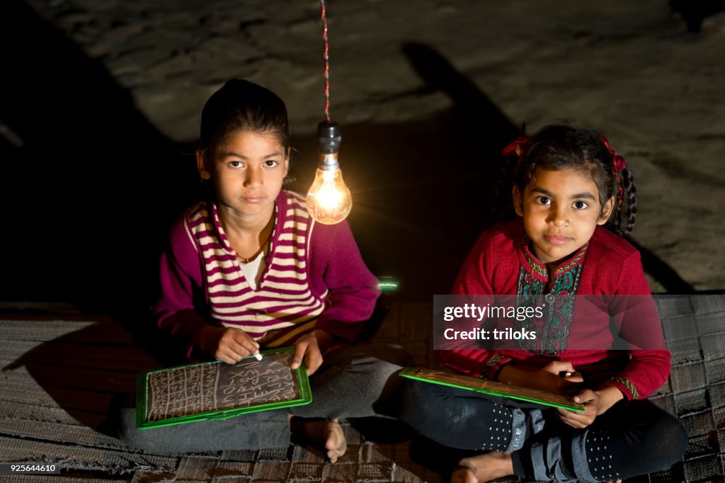 Rural girls studying in light bulb