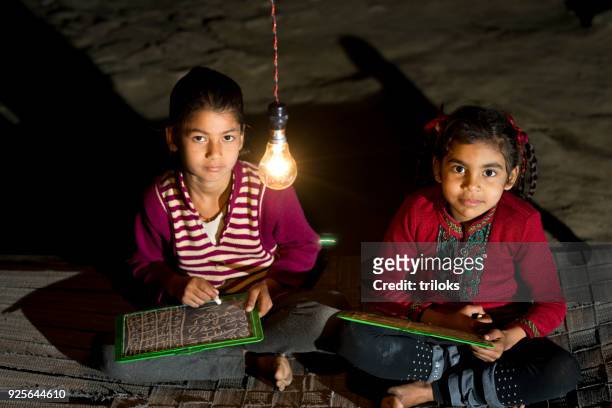 rural girls studying in light bulb - village stock pictures, royalty-free photos & images
