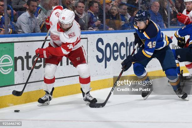 Henrik Zetterberg of the Detroit Red Wings and Ivan Barbashev of the St. Louis Blues battle for the puck at Scottrade Center on February 28, 2018 in...