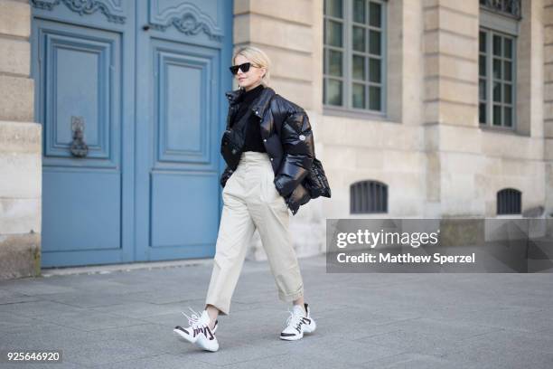 Caroline Daur is seen on the street attending Lanvin during Paris Fashion Week Women's A/W 2018 Collection wearing a black down jacket with khaki...