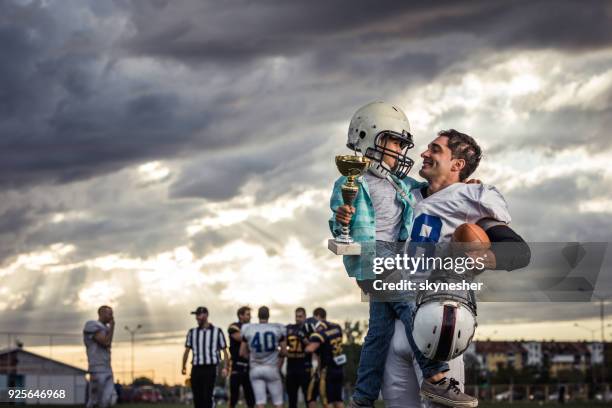 daddy, i want to be a champion in american football just like you! - american football player celebrating stock pictures, royalty-free photos & images