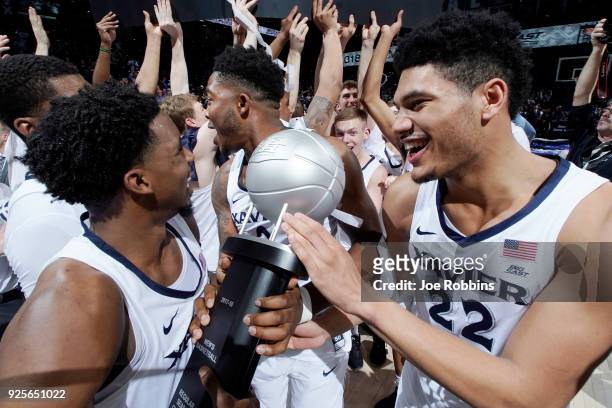 Xavier Musketeers players celebrate after winning the Big East Conference regular season title with an 84-74 win over the Providence Friars at Cintas...