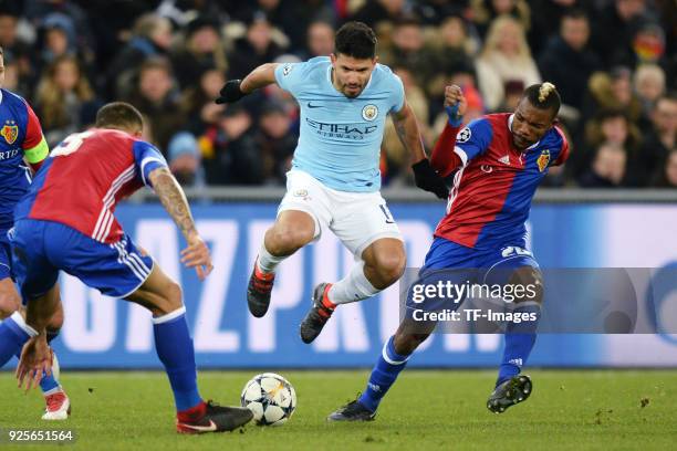 Sergio Aguero of Manchester City and Geoffroy Serey Die of Basel battle for the ball during the UEFA Champions League Round of 16 First Leg match...