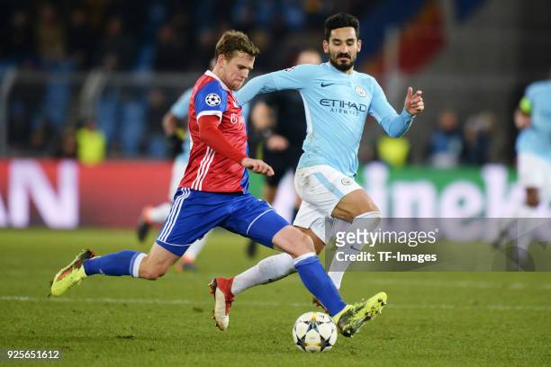 Fabian Frei of Basel and Ilkay Guendogan of Manchester City battle for the ball during the UEFA Champions League Round of 16 First Leg match between...