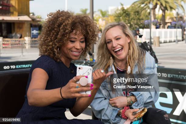 Tanika Ray and Jamie Anderson pose together at "Extra" at Universal Studios Hollywood on February 28, 2018 in Universal City, California.