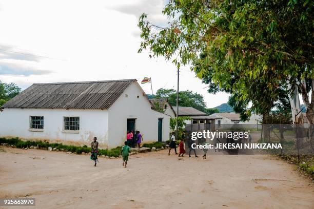 Pupils run around a school building at Lesbury Estates in Headlands east of the capital Harare on February 1 2018 days after evicted white farmer...