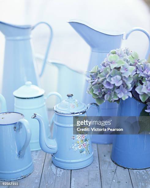 blue containers with hydrangeas - blue teapot stock pictures, royalty-free photos & images