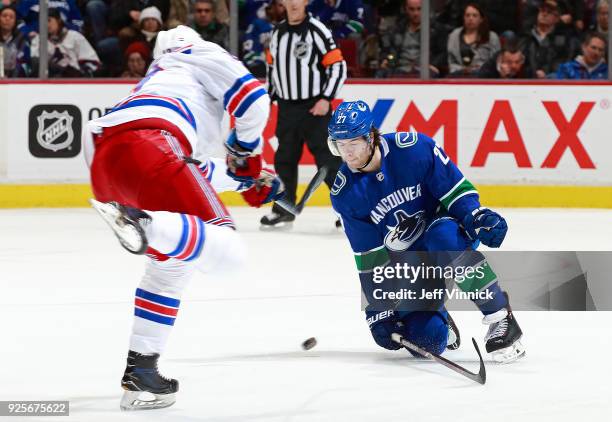 Ben Hutton of the Vancouver Canucks blocks the shot of Kevin Hayes of the New York Rangers during their NHL game at Rogers Arena February 28, 2018 in...