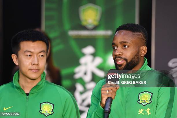 Congolese football player Cedric Bakambu speaks at a press conference by his new team Beijing Guoan in Beijing on March 1, 2018. Chinese Super League...