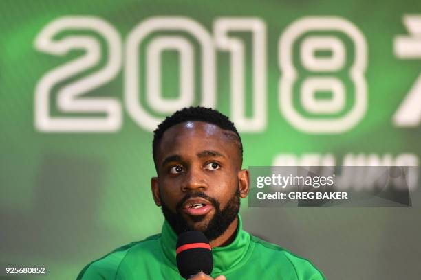 Congolese football player Cedric Bakambu speaks at a press conference by his new team Beijing Guoan in Beijing on March 1, 2018. - Chinese Super...