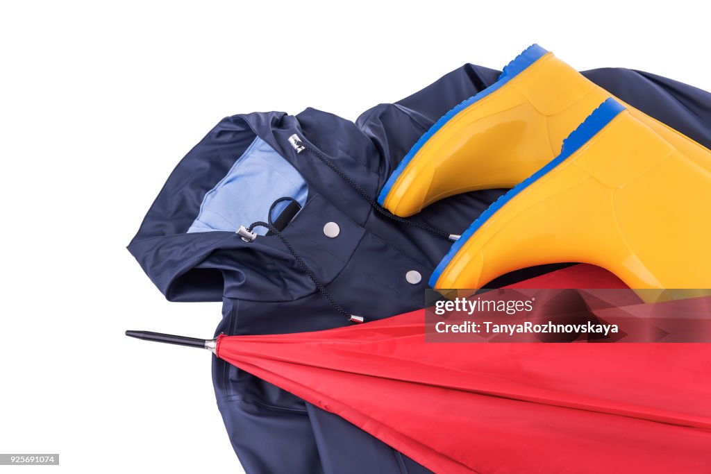 Raincoat and umbrella and rubber boots on a white background.