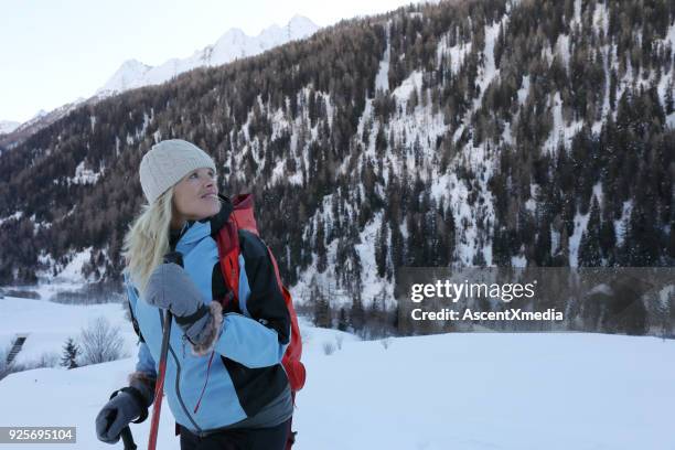 woman pause on snow slope with backcountry skiis - ski pole stock pictures, royalty-free photos & images