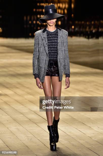 Model walks the runway during the Saint Laurent show as part of the Paris Fashion Week Womenswear Fall/Winter 2018/2019 on February 27, 2018 in...