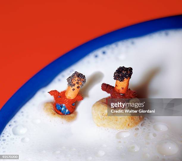 worry dolls floating in milk - giordani walter stockfoto's en -beelden