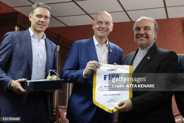 Iran's Minister of Sport and Youth Masoud Soltanifar poses for a picture with FIFA President Gianni Infantino and Dutch former football player Marco...
